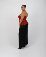 Load image into Gallery viewer, Woman wearing a red silk top and black silk palazzo trousers on a white background