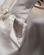 Load image into Gallery viewer, Close-up of a Paradisefold Oyster silk shirt with a button detail