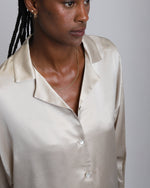 Load image into Gallery viewer, Paradisefold Woman wearing a Champagne Silk shirt against a plain background