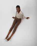 Load image into Gallery viewer, Paradisefold Person wearing a oyster champagne silk shirt and brown pants on a white background
