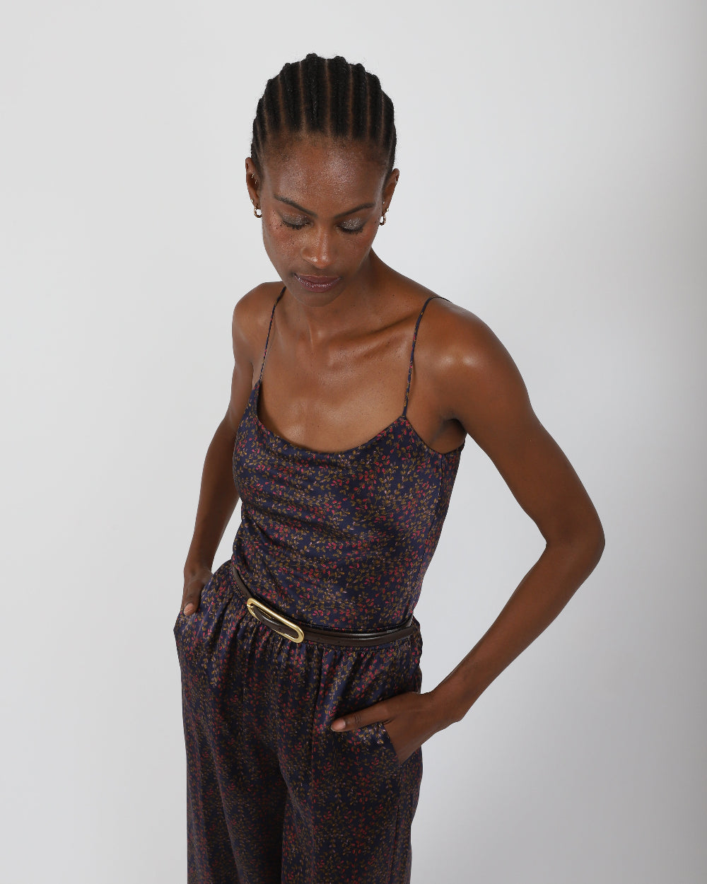 Woman wearing a patterned dress with a belt on a plain background, by Paradisefold